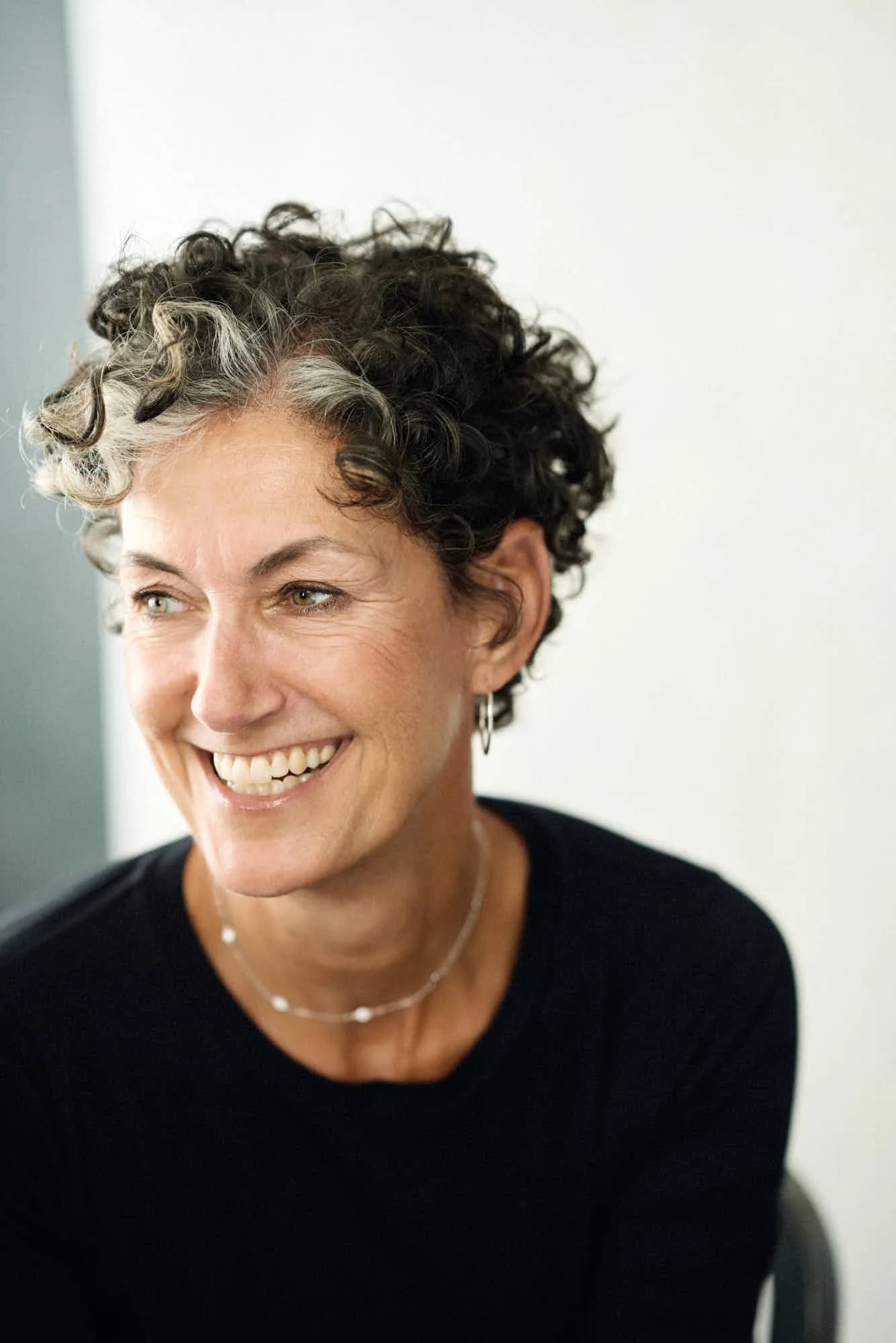 Nancy Giordano standing in a studio, smiling